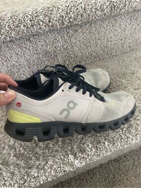 On Running Shoes in Light Gray with Black and Yellow Accents